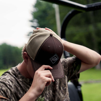 Muck® Diamond Trucker Hat, MACS900, Brown hat. man adjusting muck hat. Richardson Hats.