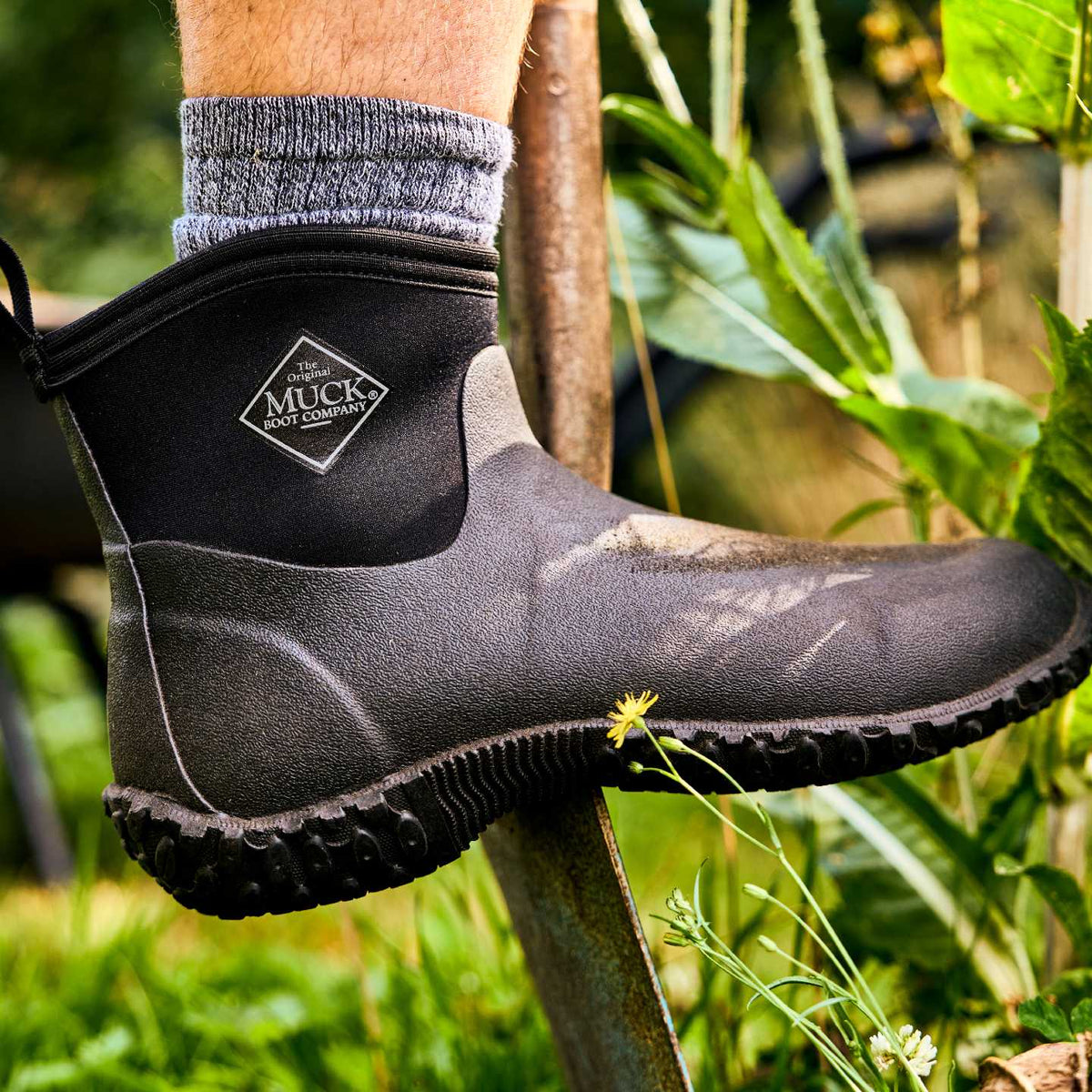 M2A000 Muckster II Men's Ankle Muck boot worn by a person in a garden setting