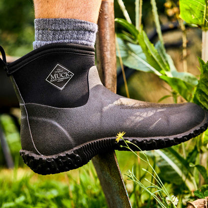 M2A000 Muckster II Men's Ankle Muck boot worn by a person in a garden setting