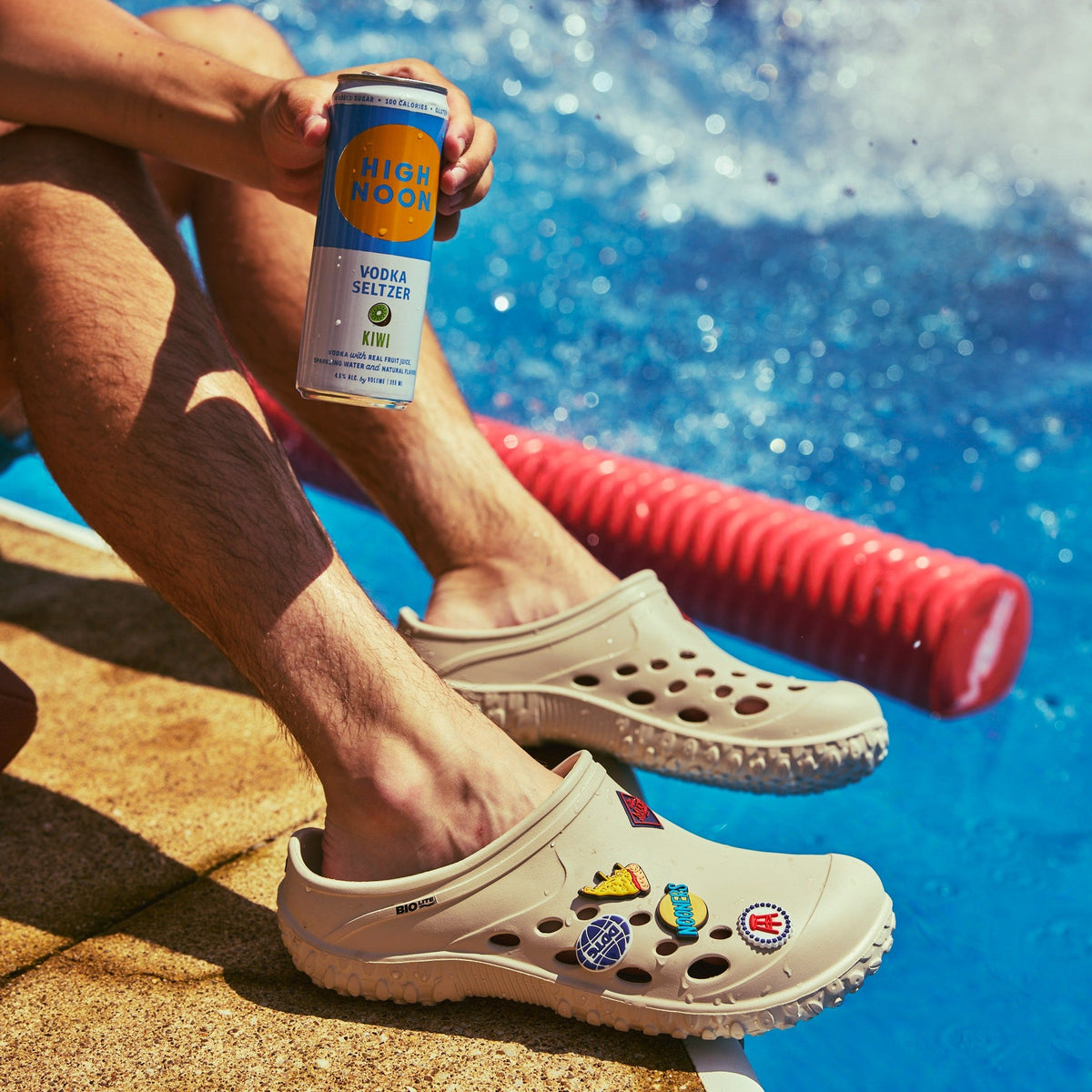 Barstool Sports - Man wearing Muckster Lite Clogs sitting next to a pool.
