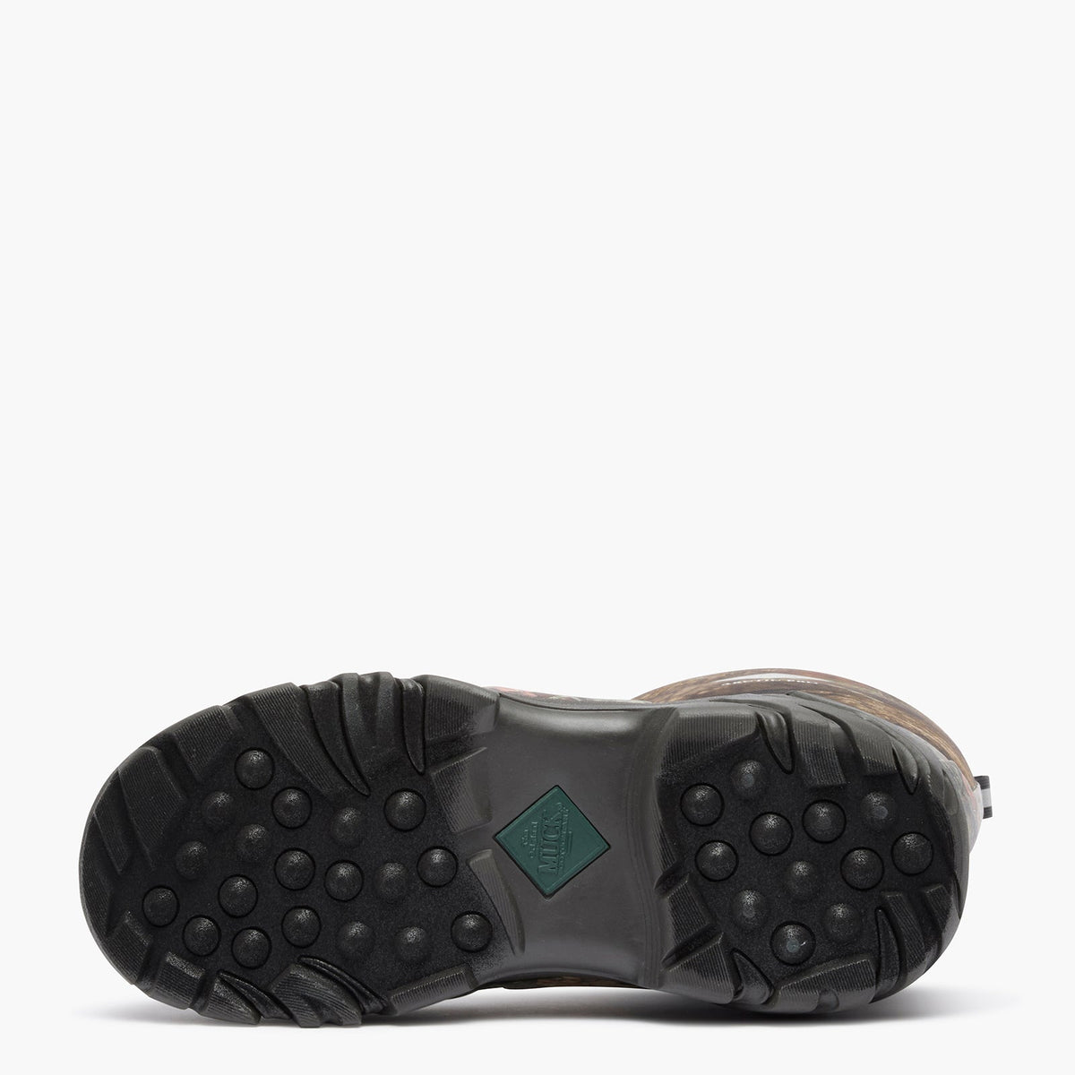 The outsole of a brown boot with a black treaded rubber bottom and a small green diamond-shaped logo patch, shown against a plain white background.