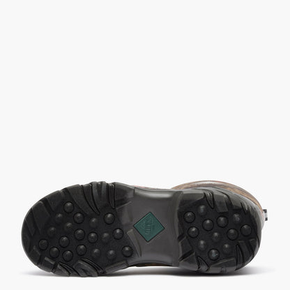 The outsole of a brown boot with a black treaded rubber bottom and a small green diamond-shaped logo patch, shown against a plain white background.