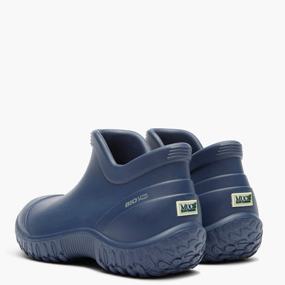 Pair of blue slip-on shoes with a visible brand logo on a white background