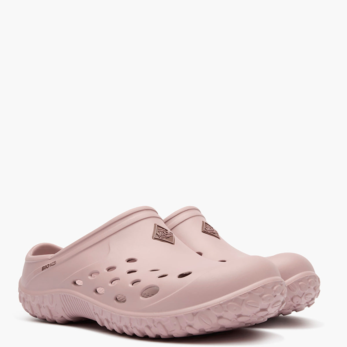 Pair of light pink clogs on a white background