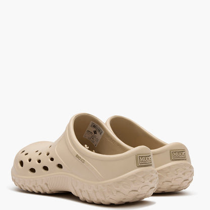 Pair of beige clogs on a white background